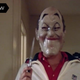 A man wearing a mask and jogging suit holds a knife in a scene from New Year's Evil.
